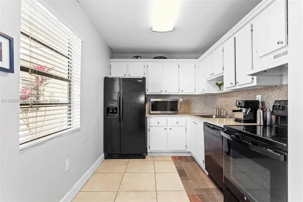 a kitchen with a refrigerator a sink and a stove