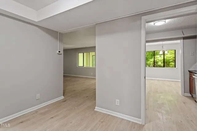 an empty room with windows and closet
