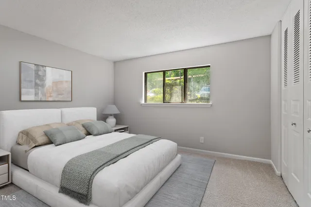 a bedroom with a bed and a window