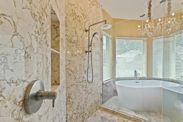 a view of a lake with a yard and a wooden fence