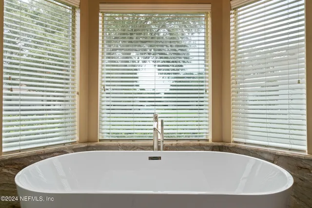 an aerial view of a house with a garden and lake view