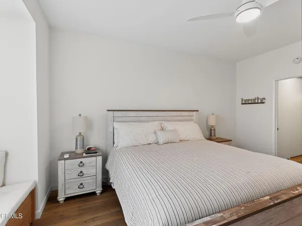 a bedroom with a white bed and white walls