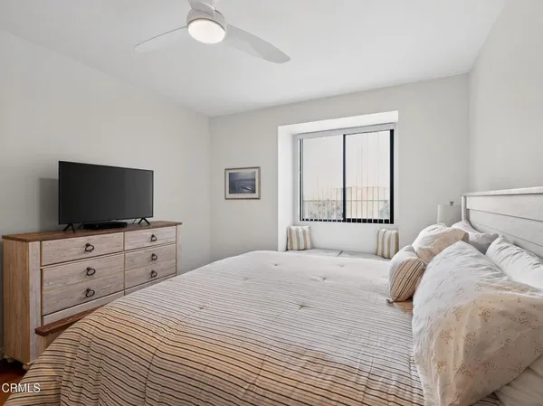 a bedroom with a large bed and a flat screen tv