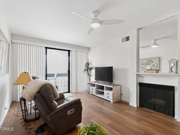 a living room with furniture a fireplace and a flat screen tv