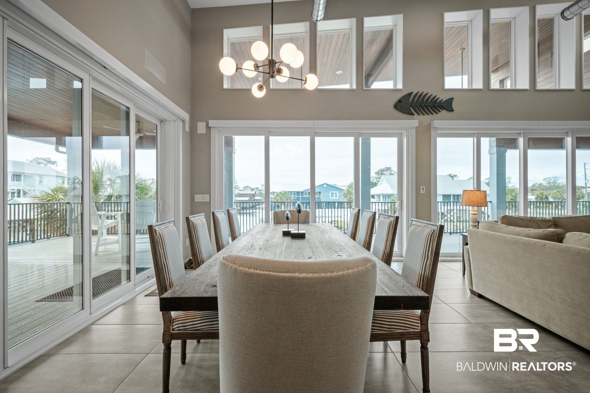 3840 Cotton Way Orange Beach, AL 36561 - Photo 7 of 75 Dining room with a chandelier, a high ceiling, and a wealth of natural light