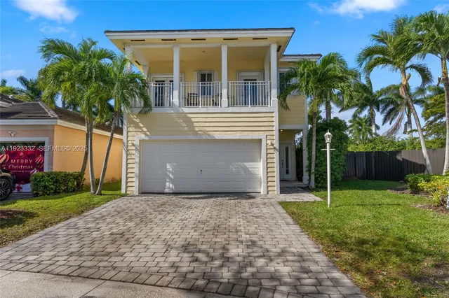 a front view of a house with a yard and a garage