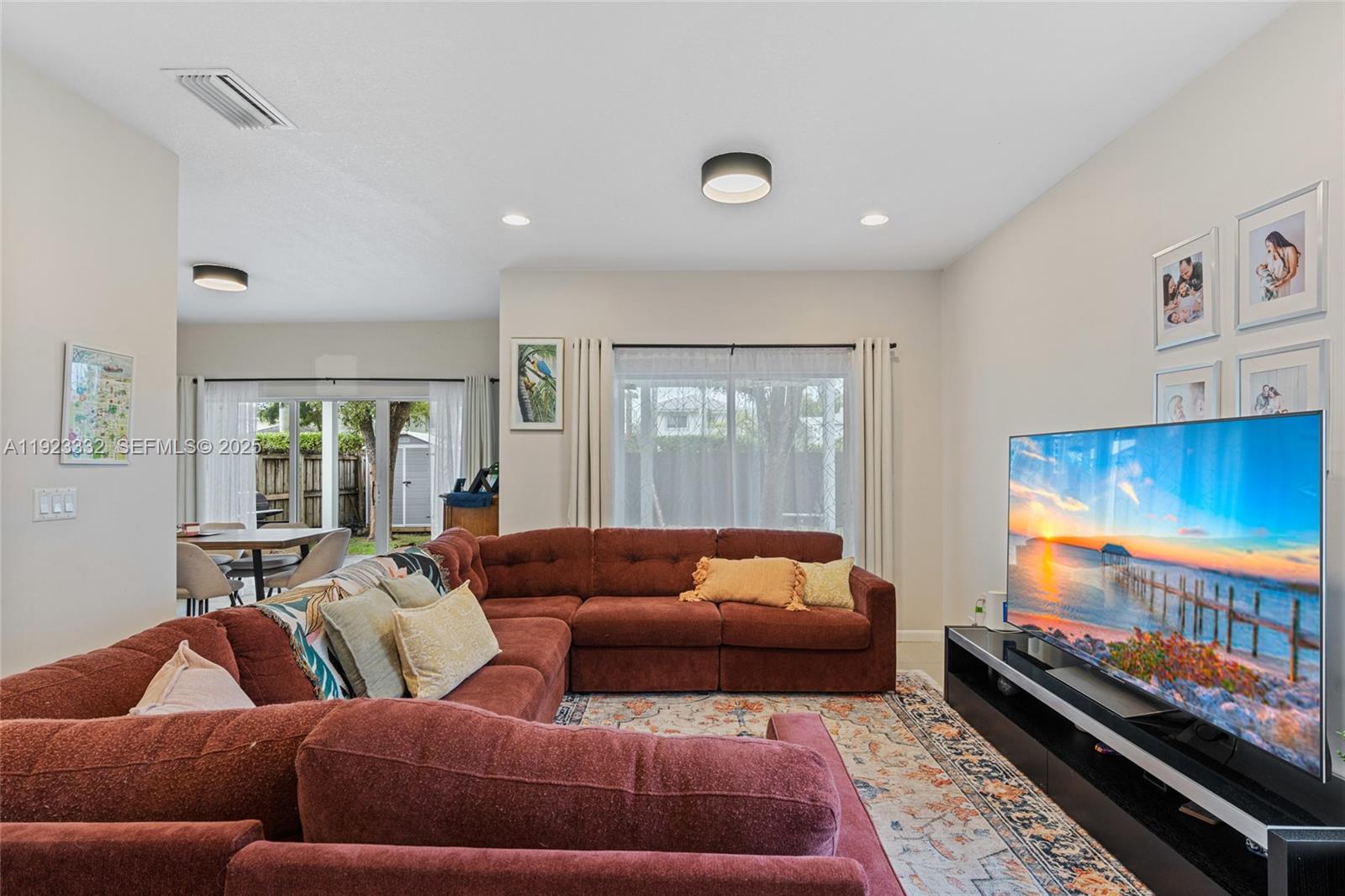 396 Northeast 33rd Terrace Homestead, FL 33033 - Photo 11 of 42 a living room with furniture and a flat screen tv