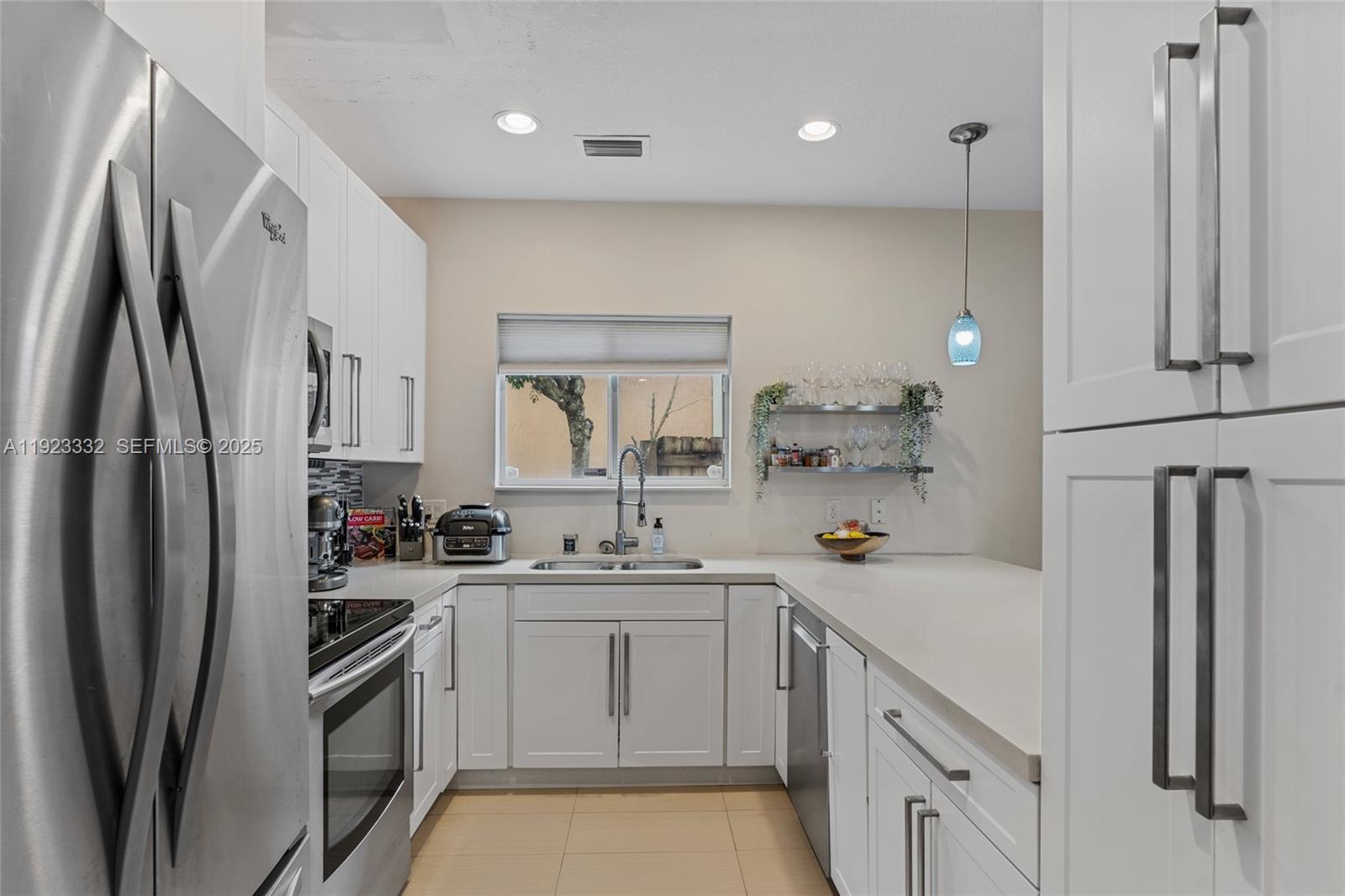 396 Northeast 33rd Terrace Homestead, FL 33033 - Photo 16 of 42 a kitchen with a sink stainless steel appliances and cabinets