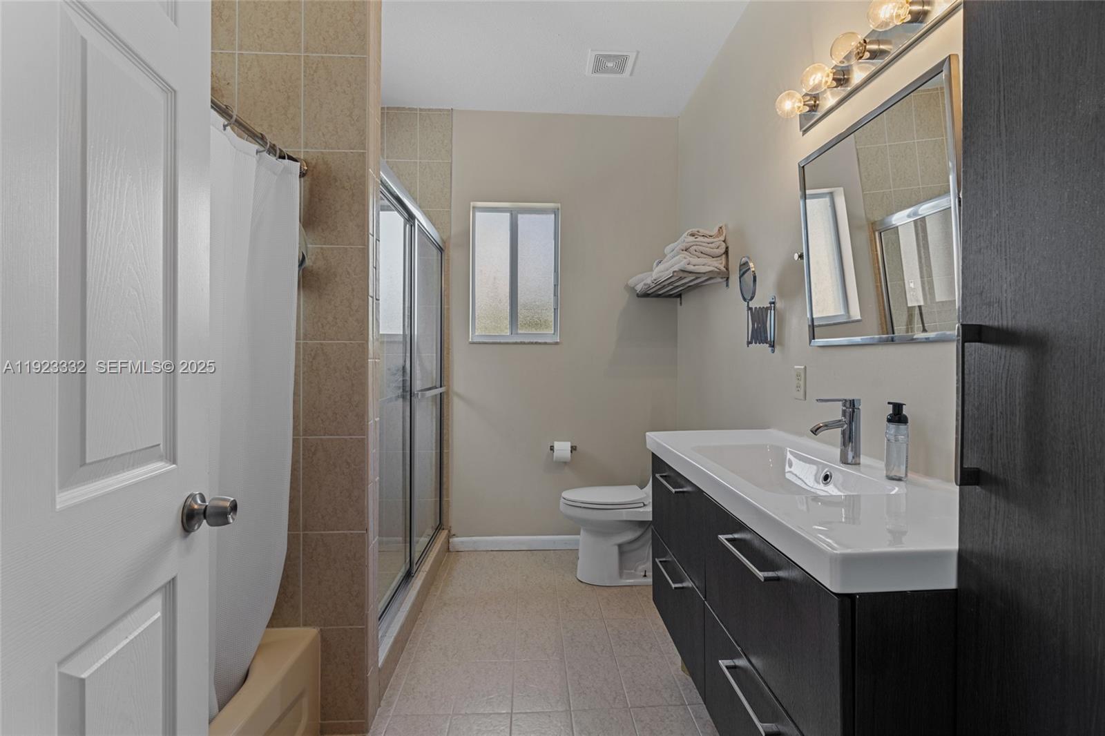 396 Northeast 33rd Terrace Homestead, FL 33033 - Photo 23 of 42 a bathroom with a sink and mirror with toilet