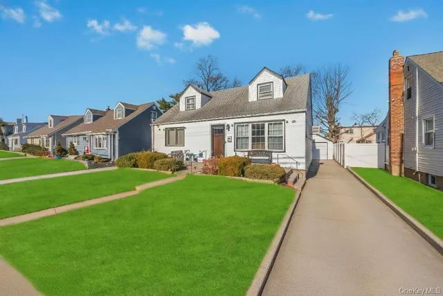a front view of house with yard and green space
