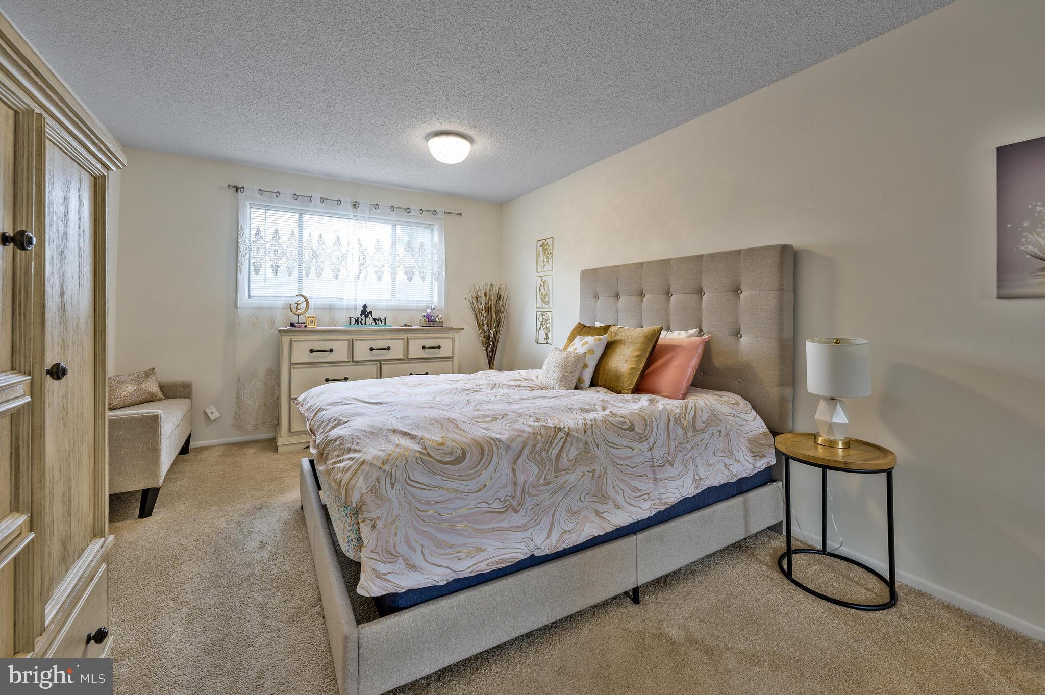 56 Dover Drive Lindenwold, NJ 08021 - Photo 14 of 20 a bed sitting in a spacious bedroom next to a window and a larger closet