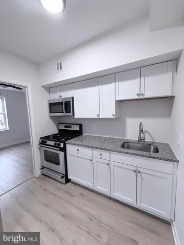 a kitchen with granite countertop a stove and a sink