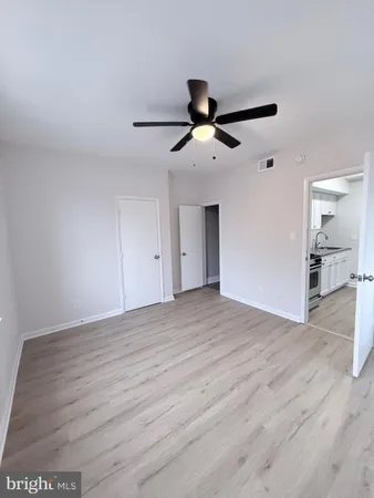 a view of an empty room and wooden floor