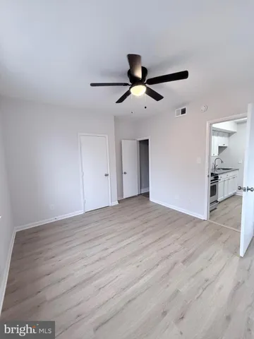 a view of an empty room and wooden floor