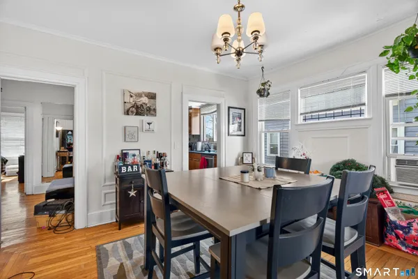 a view of a dining room with furniture window and wooden floor