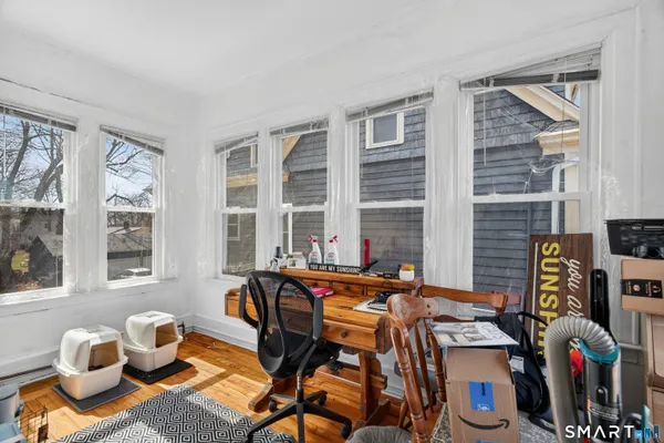 a table and chair sitting in a room with a window
