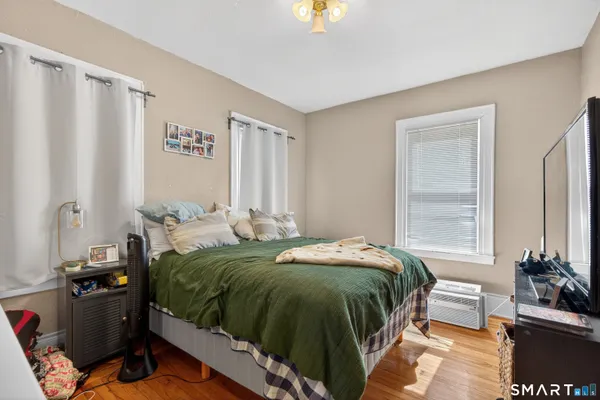 a bedroom with a bed and a couch
