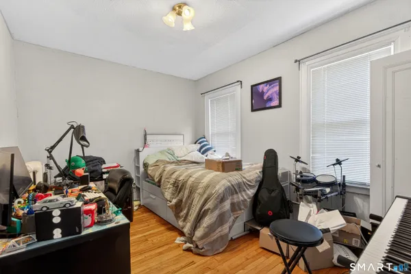 a bed room with bed and a chair