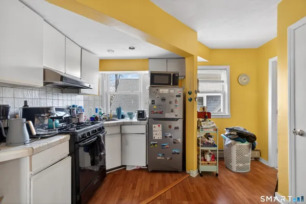 a kitchen with a sink a refrigerator and cabinets