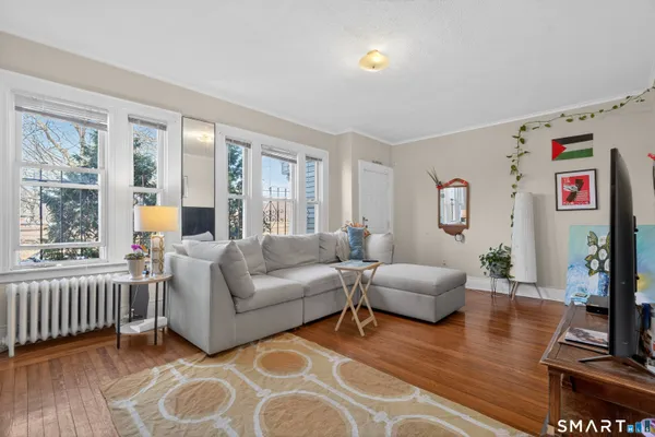 a living room with furniture and a flat screen tv