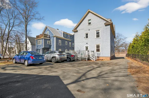a view of a many cars parked in front of a house