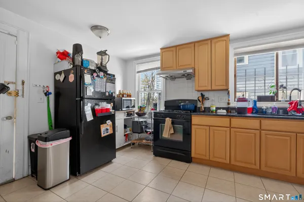 a kitchen with granite countertop a sink appliances and cabinets