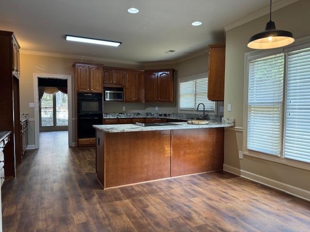 a kitchen with stainless steel appliances granite countertop a stove a sink and a refrigerator