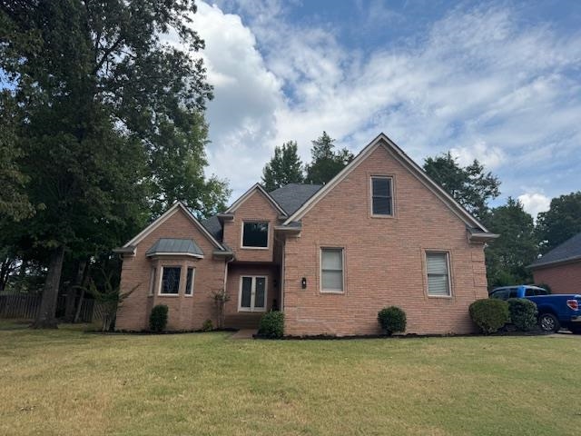 8668 Stablemill Lane Memphis, TN 38016 - Photo 26 of 36 a front view of a house with a yard