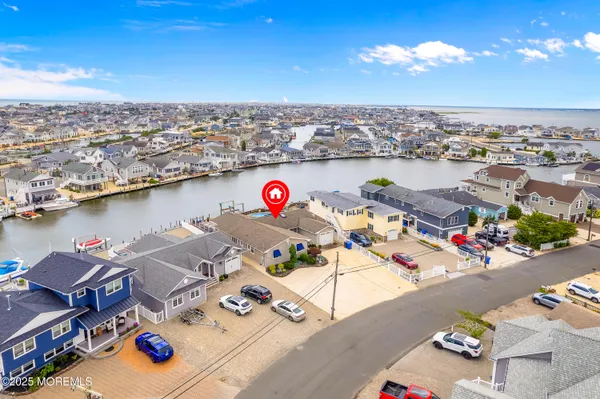 a dining room with furniture potted plants and wooden floor