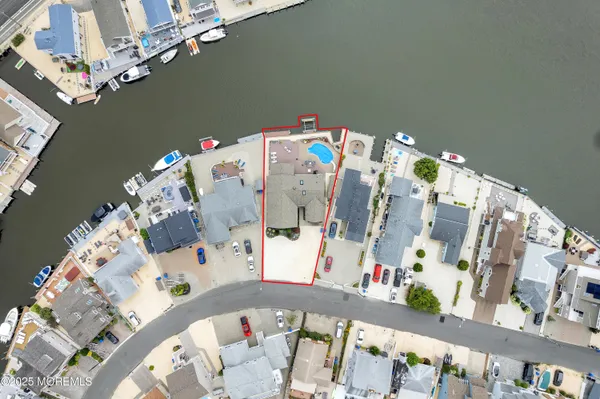 a dining room with furniture a potted plant and wooden floor