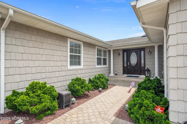 a kitchen with stainless steel appliances kitchen island granite countertop a table chairs in it and wooden floors