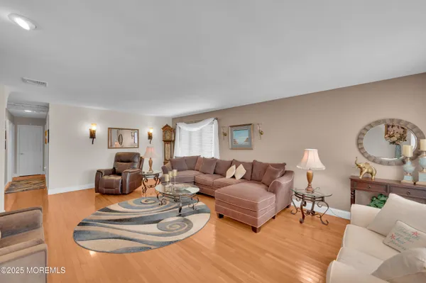 a large kitchen with kitchen island granite countertop a large window and stainless steel appliances