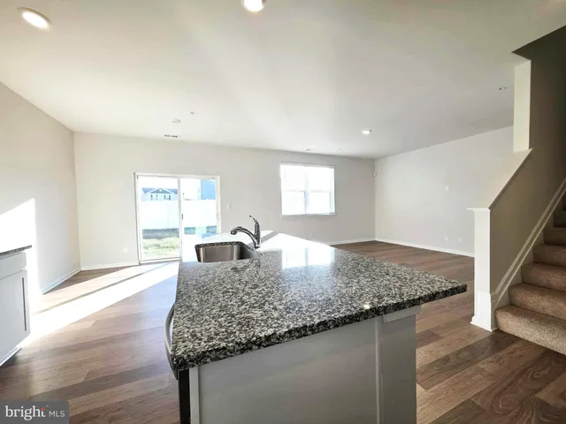 a kitchen with a sink a stove and refrigerator