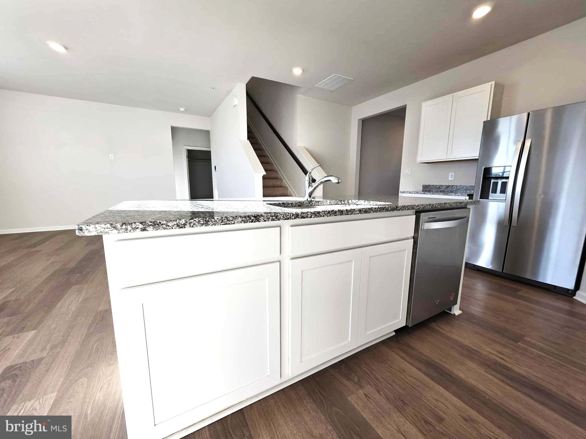 374 Robbins Farm Road Cambridge, MD 21613 - Photo 20 of 48 a kitchen with stainless steel appliances granite countertop a refrigerator a sink a stove and white cabinets