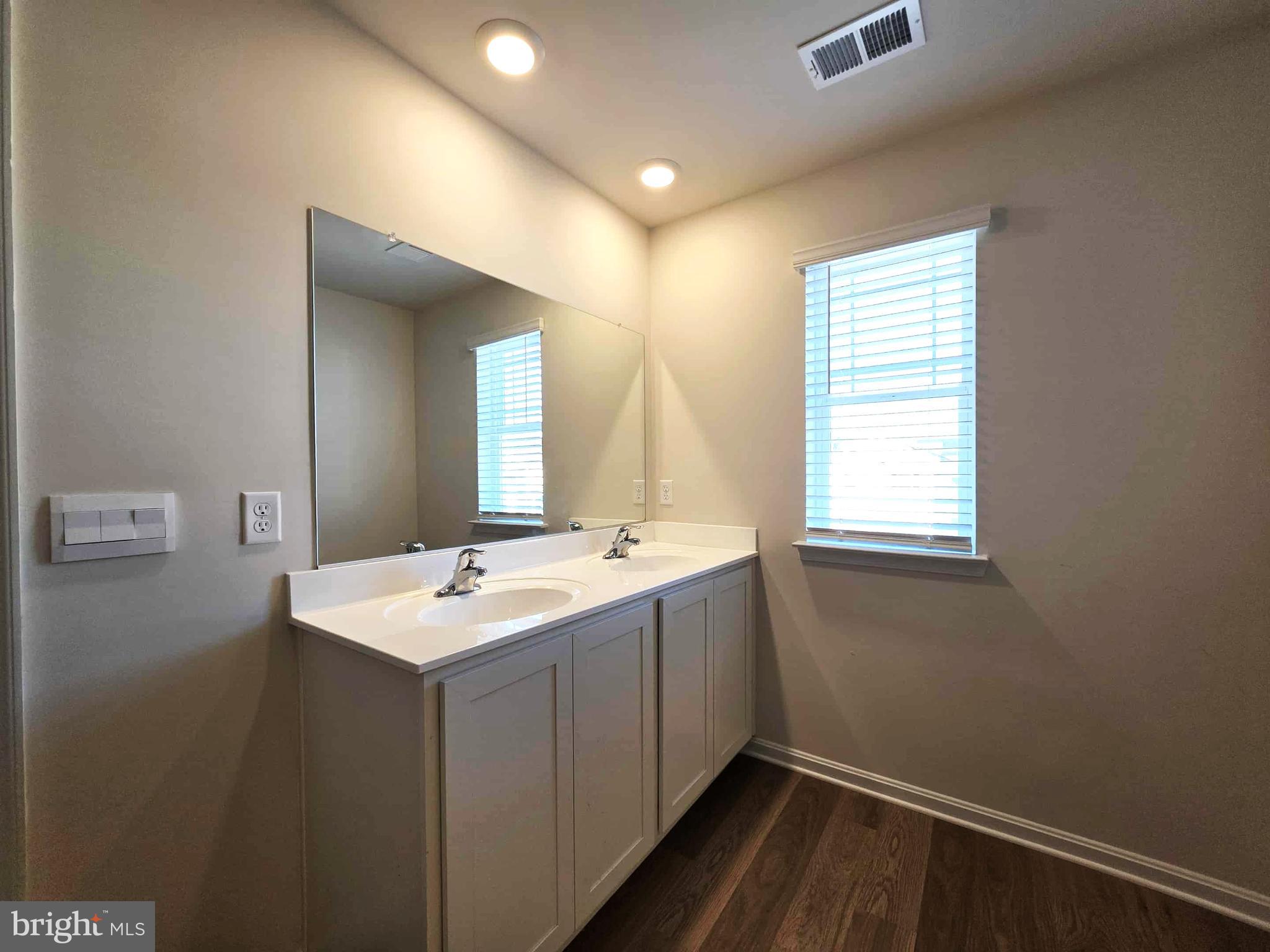 374 Robbins Farm Road Cambridge, MD 21613 - Photo 33 of 48 a bathroom with a sink a mirror and a window
