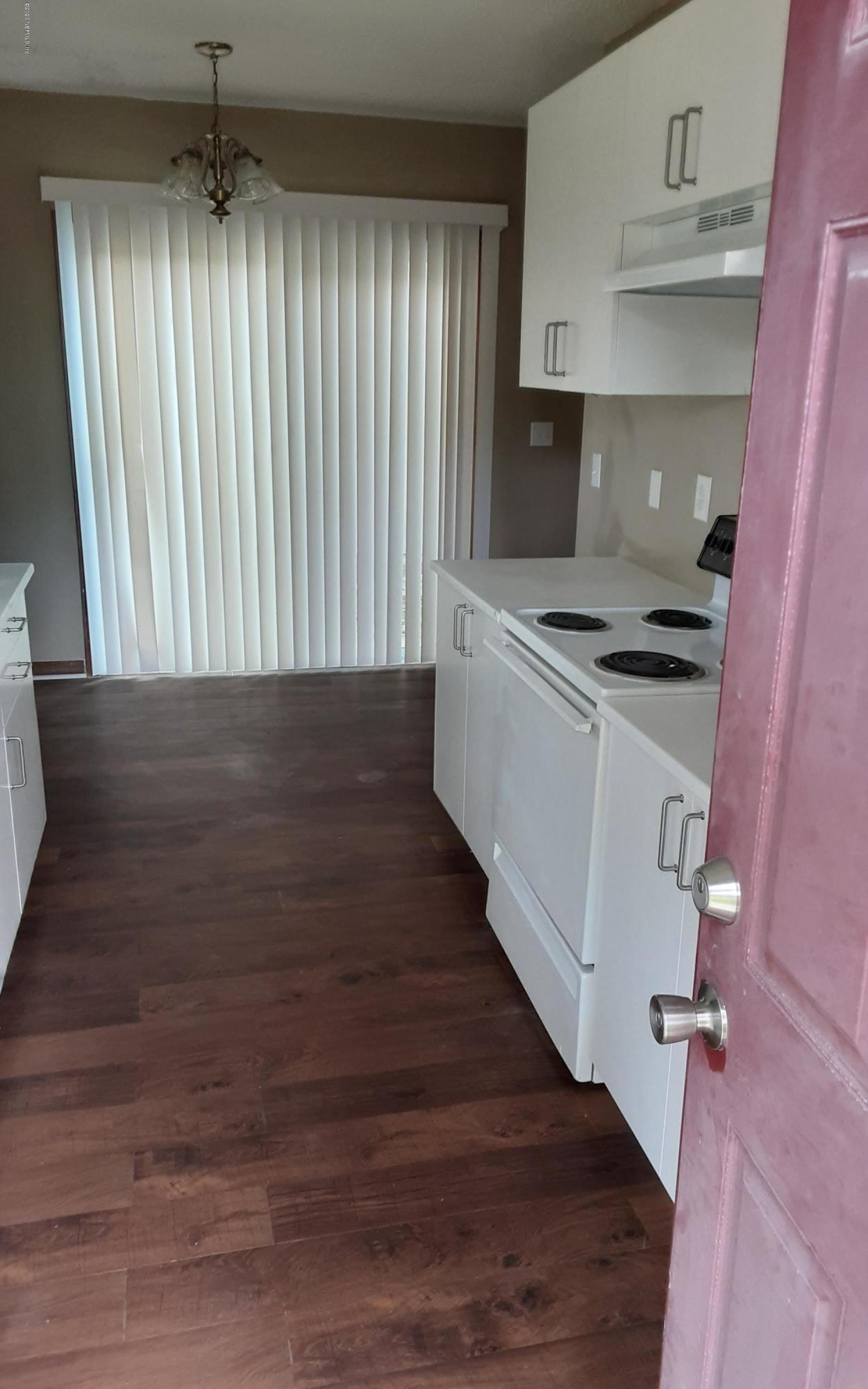 2100 Cornell Road Middleburg, FL 32068 - Photo 12 of 20 wooden floor in an empty room with a stove