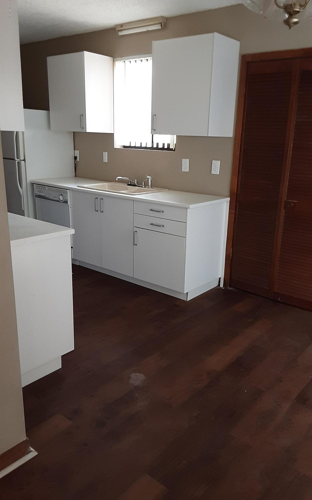 2100 Cornell Road Middleburg, FL 32068 - Photo 17 of 20 a view of a kitchen with stainless steel appliances wooden floor and a sink
