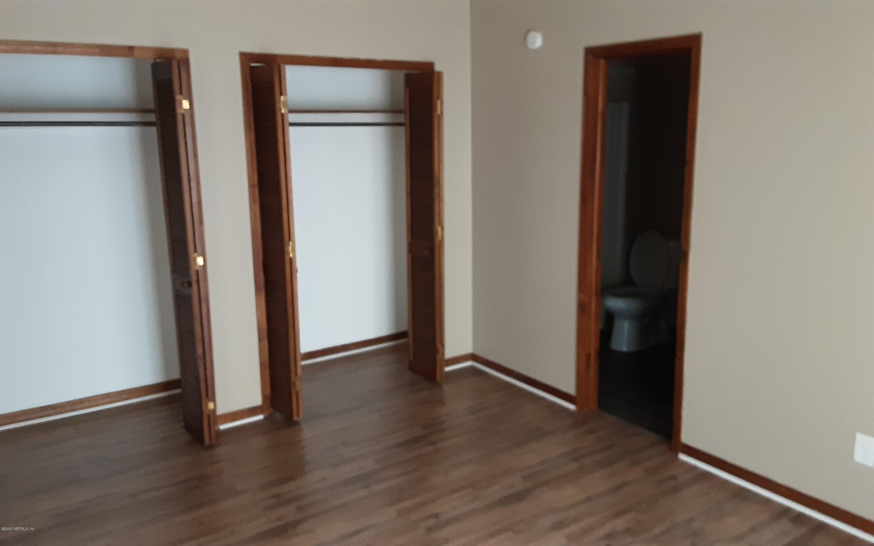 2100 Cornell Road Middleburg, FL 32068 - Photo 7 of 20 an empty room with wooden floor and closet