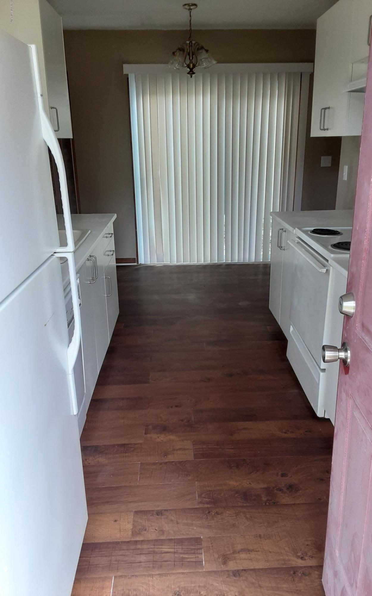 2100 Cornell Road Middleburg, FL 32068 - Photo 10 of 20 a view of a hallway with wooden floor and staircase