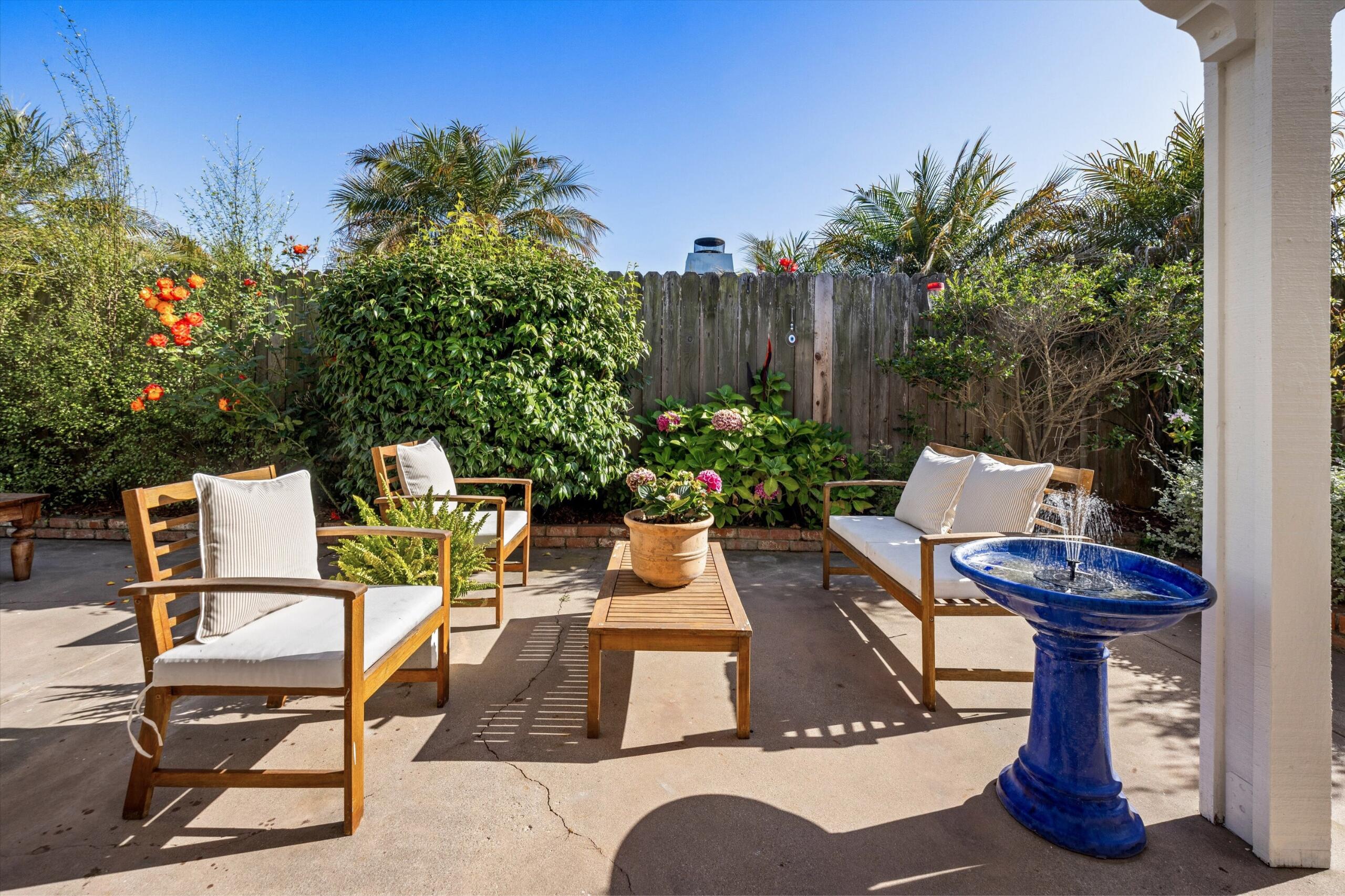 4565 Chapparral Drive Carpinteria, CA 93013 - Photo 18 of 23 a view of a patio with table and chairs potted plants and palm tree