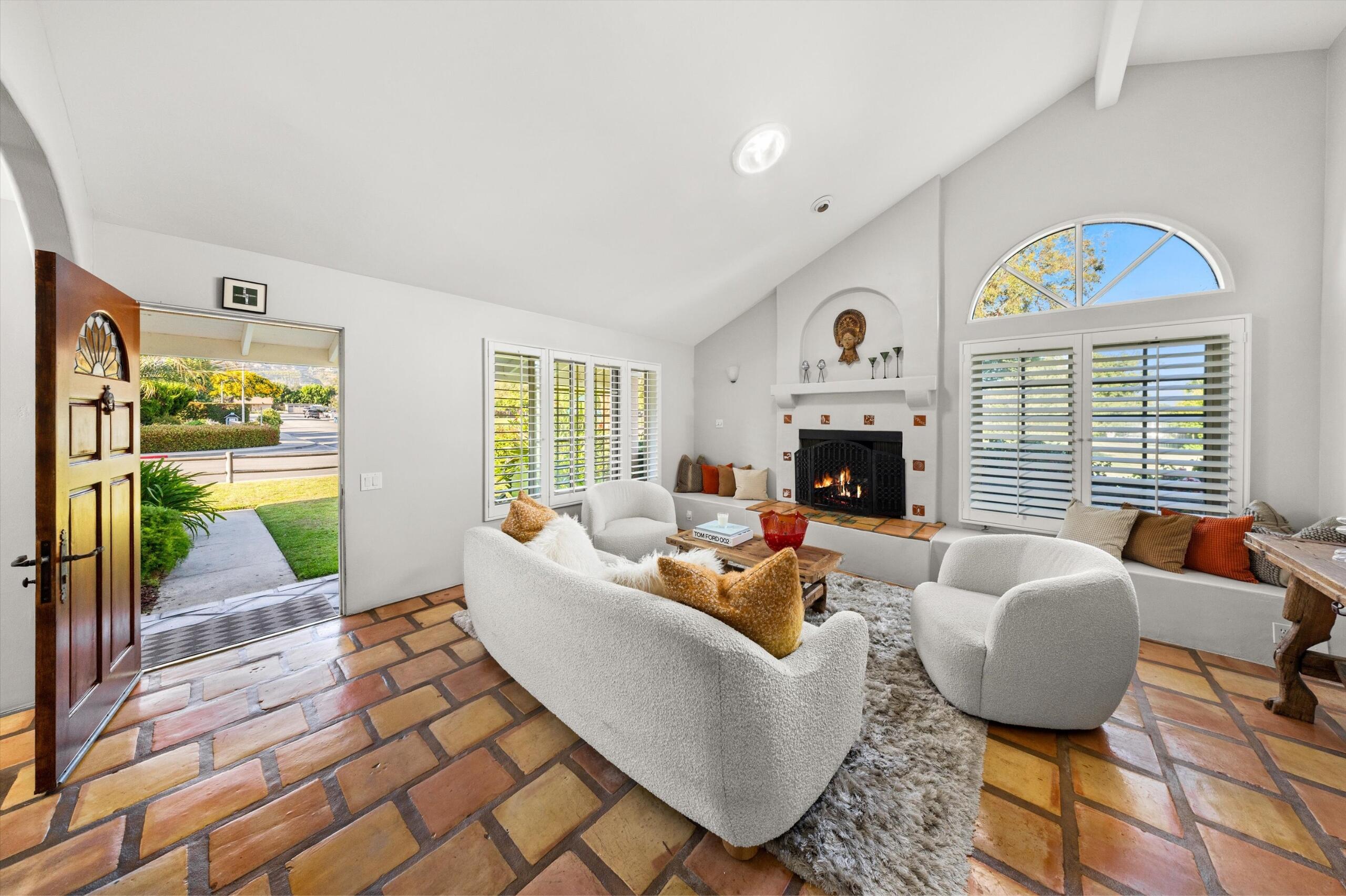 4565 Chapparral Drive Carpinteria, CA 93013 - Photo 5 of 23 a living room with fireplace furniture and a large window