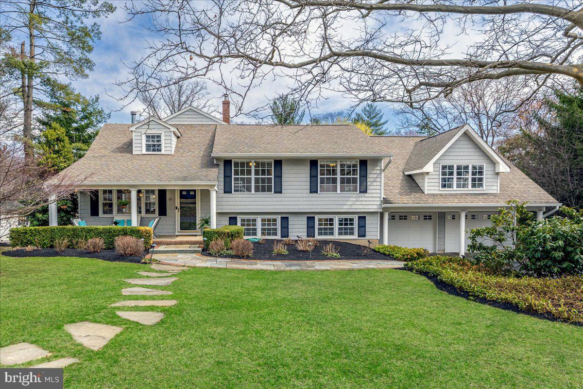 a front view of a house with a yard table and chairs