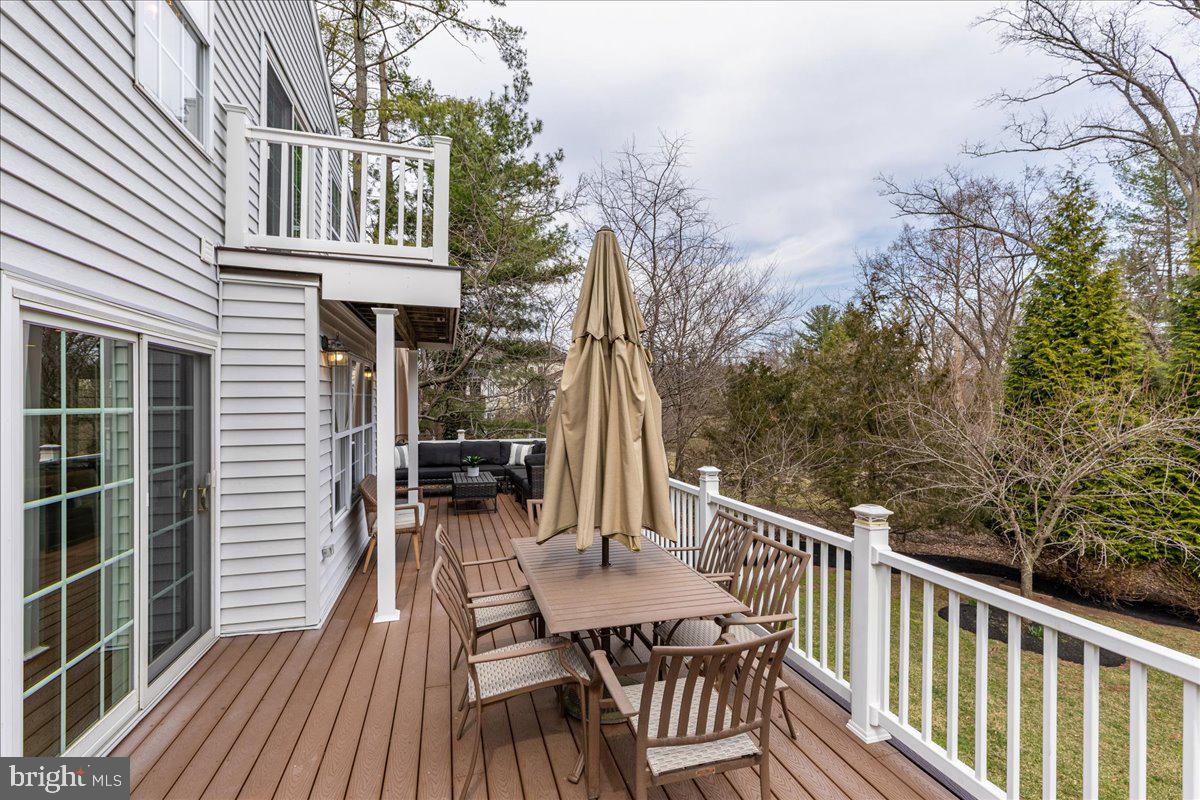 67 Randall Road Princeton, NJ 08540 - Photo 40 of 47 a view of a deck with chairs and wooden floor and fence