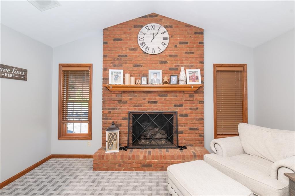 301 Forest Ridge Road Indiana, PA 15701 - Photo 13 of 41 a living room with furniture a clock and a fireplace
