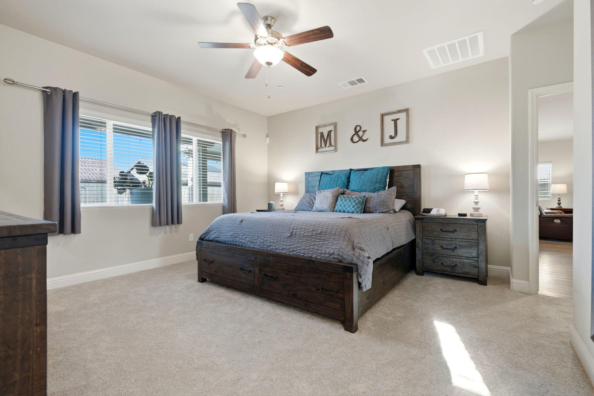 756 Strada Street Lemoore, CA 93245 - Photo 30 of 53 a bedroom with a bed and glass walk in closet