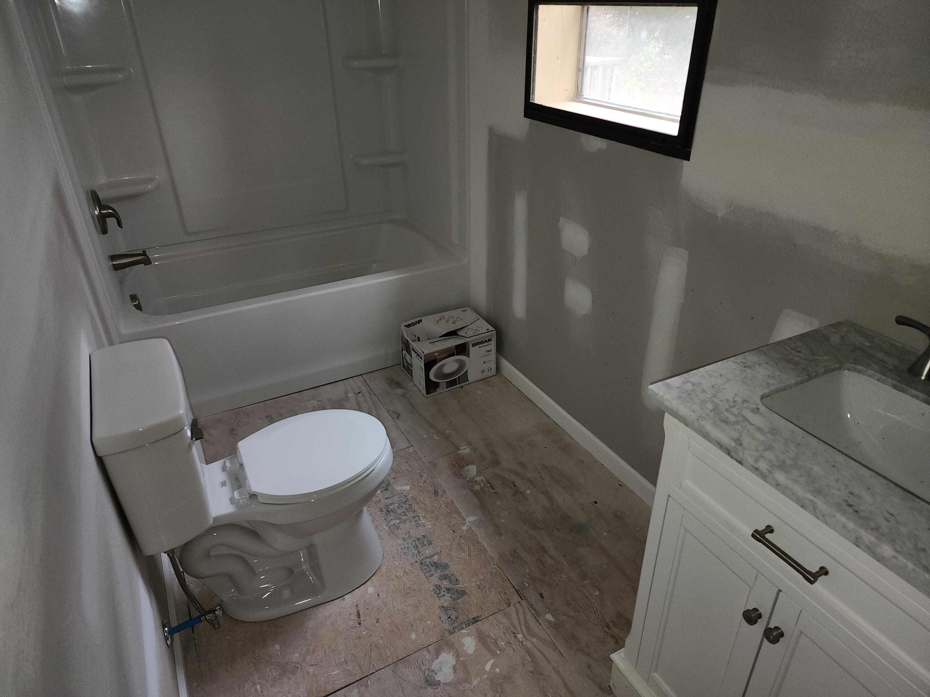1617 Navigation Point Goodview, VA 24095 - Photo 5 of 12 a bathroom with a granite countertop toilet sink and mirror