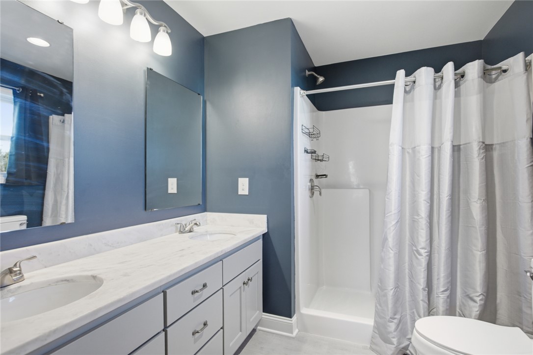 745 Dave Nix Road Seneca, SC 29678 - Photo 11 of 32 This bathroom features a double vanity and a pristine shower, perfect for daily routines.