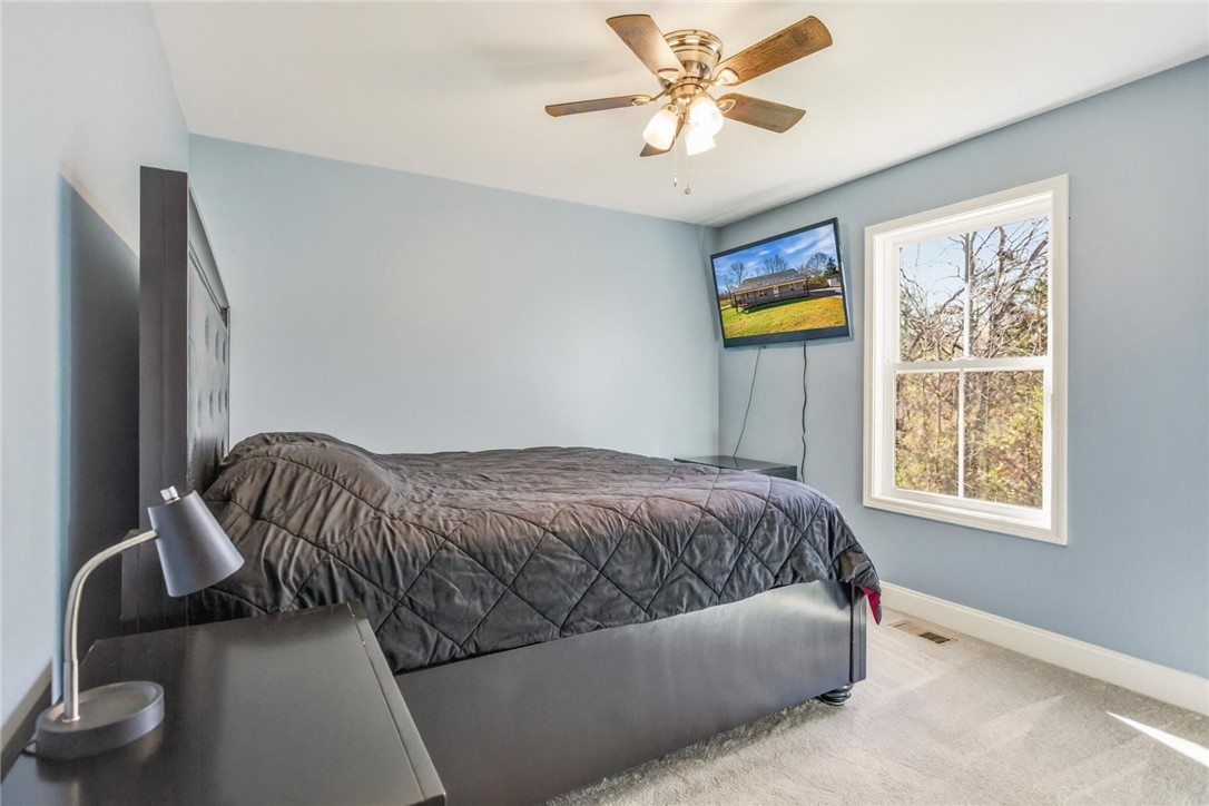 745 Dave Nix Road Seneca, SC 29678 - Photo 22 of 32 This inviting bedroom provides a comfortable retreat with ample natural light.