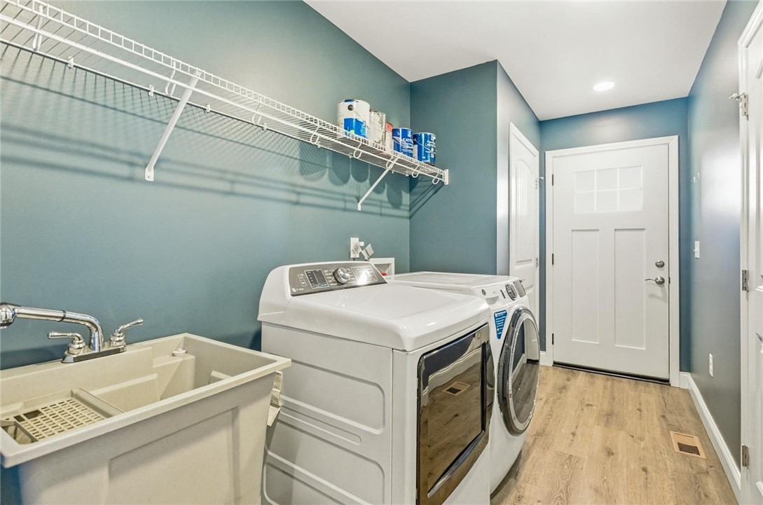 745 Dave Nix Road Seneca, SC 29678 - Photo 23 of 32 This dedicated laundry space offers convenience with a utility sink and essential appliances.