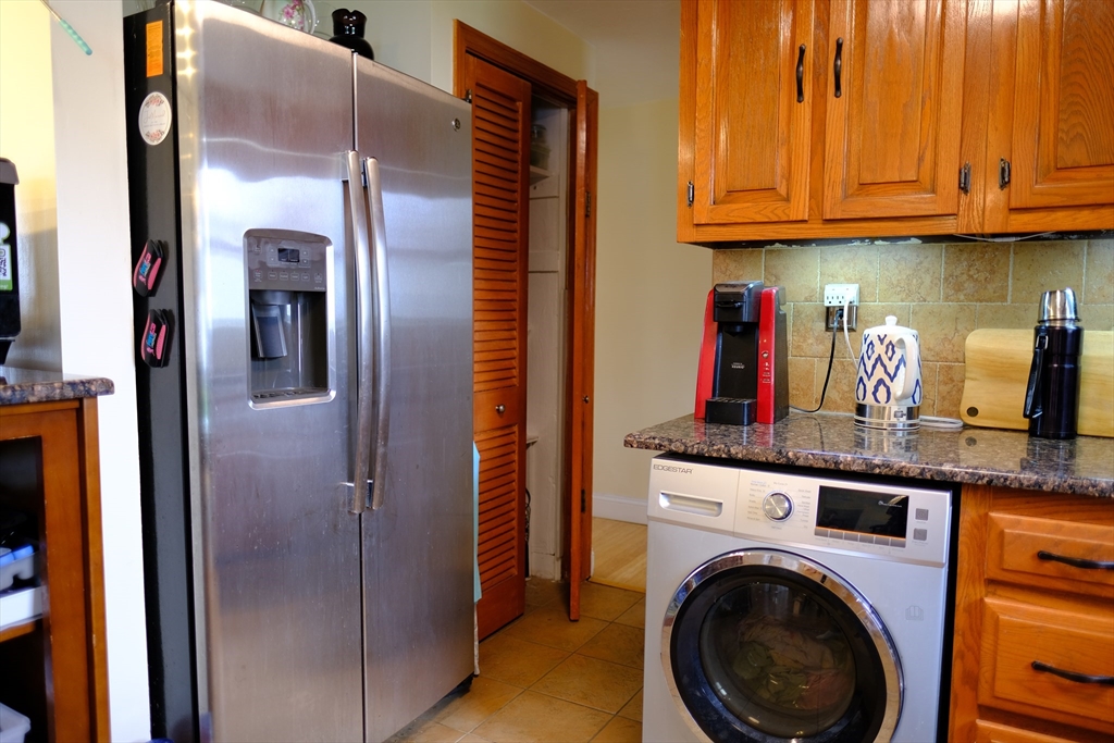 9 Stanley Street Natick, MA 01760 - Photo 17 of 42 a view of a kitchen with stainless steel appliances granite countertop a refrigerator and cabinets